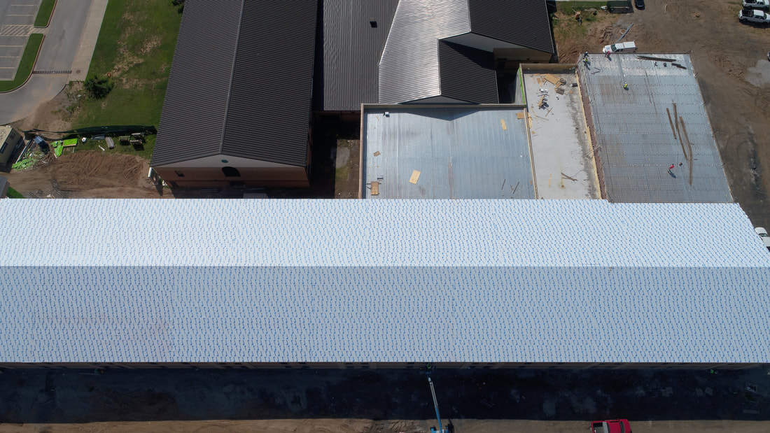 Aerial view of a commercial roofing project completed by American Roofing